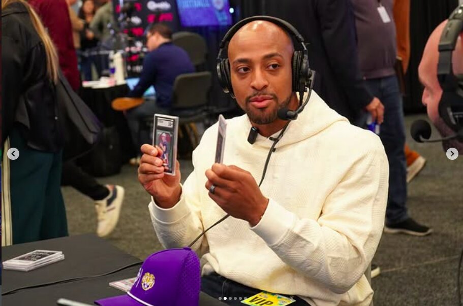 AJ Dillon holds up cards from his collection during The National's Super Bowl media-row activation