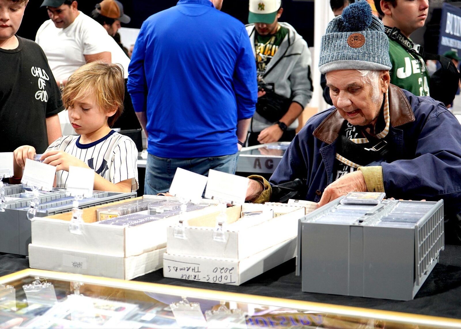 Collectors of every generation sort through boxes of cards at The National